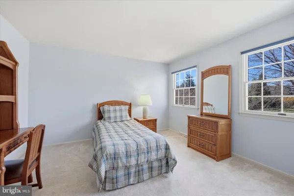 a bedroom with furniture and a large window