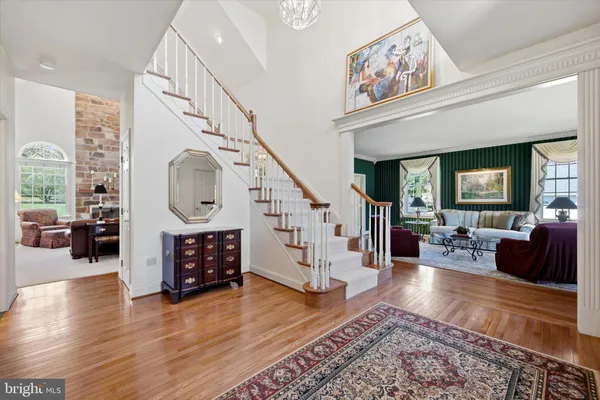 a living room with fireplace furniture and a wooden floor