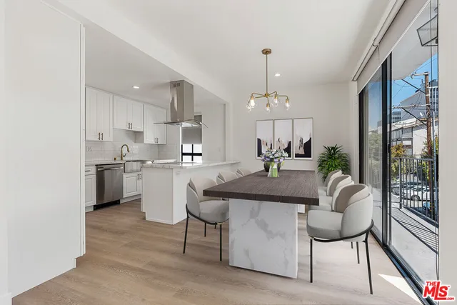a living room with kitchen island furniture and a chandelier