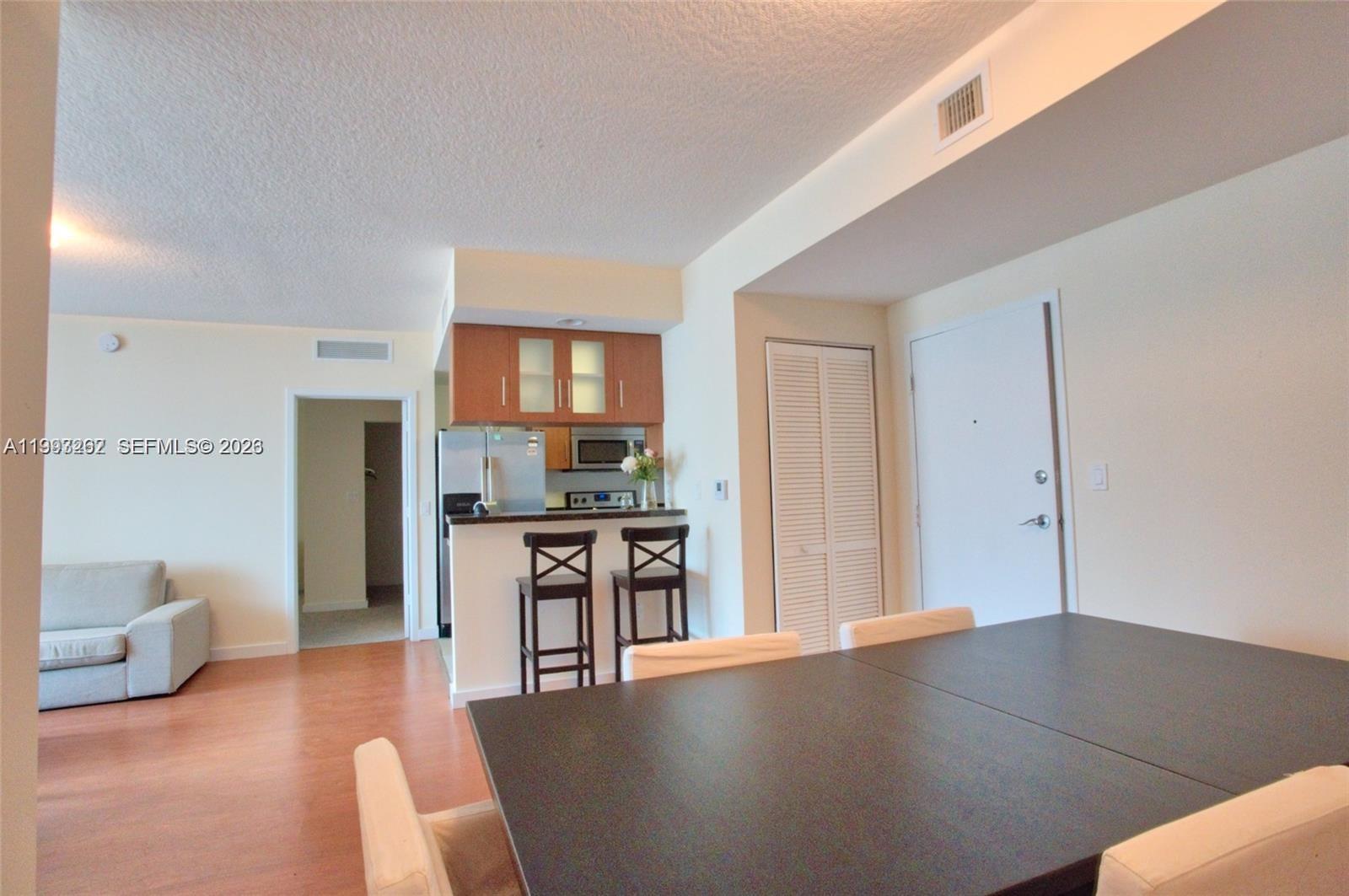 601 Northeast 23rd Street, Unit 1004 Miami, FL 33137 - Photo 3 of 17 a living room with stainless steel appliances furniture a kitchen view and a refrigerator