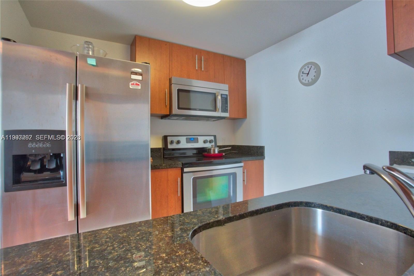 601 Northeast 23rd Street, Unit 1004 Miami, FL 33137 - Photo 7 of 17 a kitchen with stainless steel appliances granite countertop a refrigerator a stove and a sink
