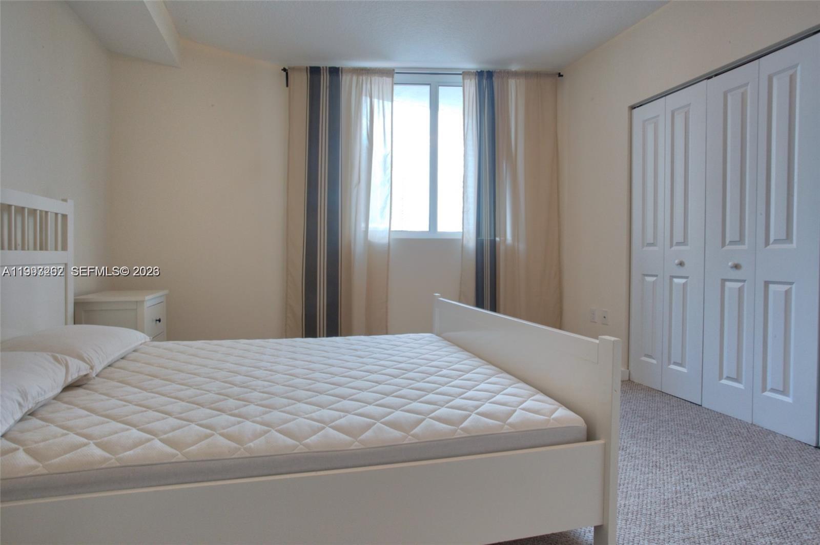 601 Northeast 23rd Street, Unit 1004 Miami, FL 33137 - Photo 9 of 17 a bedroom with a bed and a window