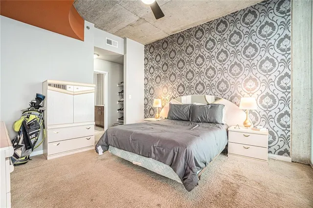 a bedroom with a bed and a chair