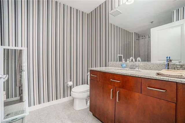 a spacious bathroom with a double vanity sink and a mirror