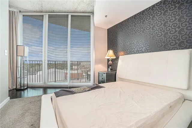 a bedroom with a bed and a large window