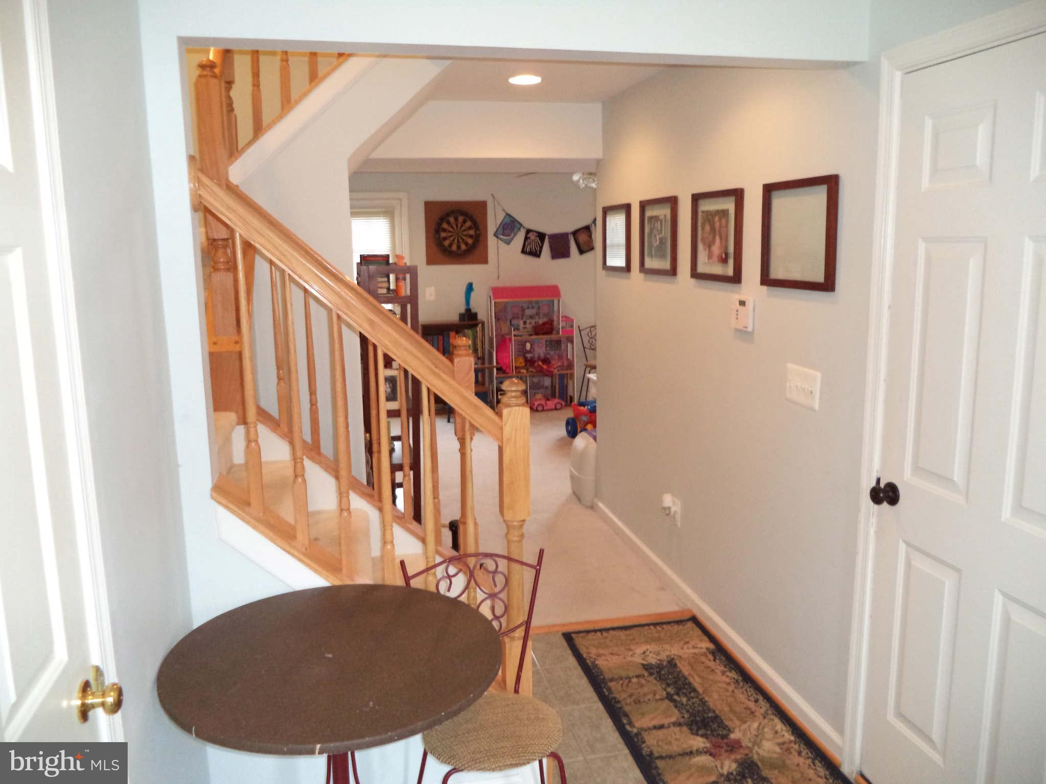 1335 Steed Street Ranson, WV 25438 - Photo 3 of 17 a view of staircase with lots of frames on wall and a window