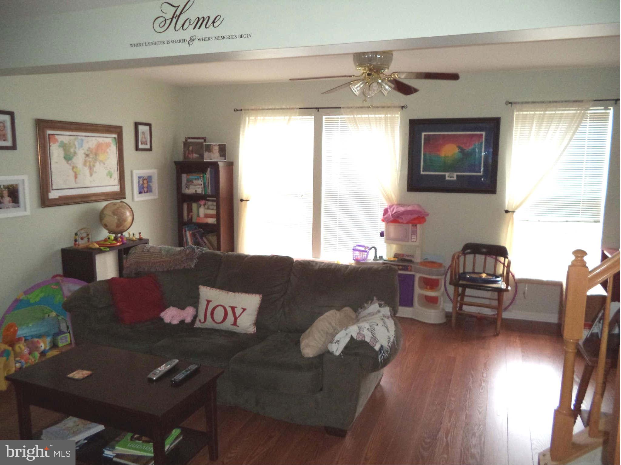 1335 Steed Street Ranson, WV 25438 - Photo 8 of 17 a living room with furniture and a flat screen tv
