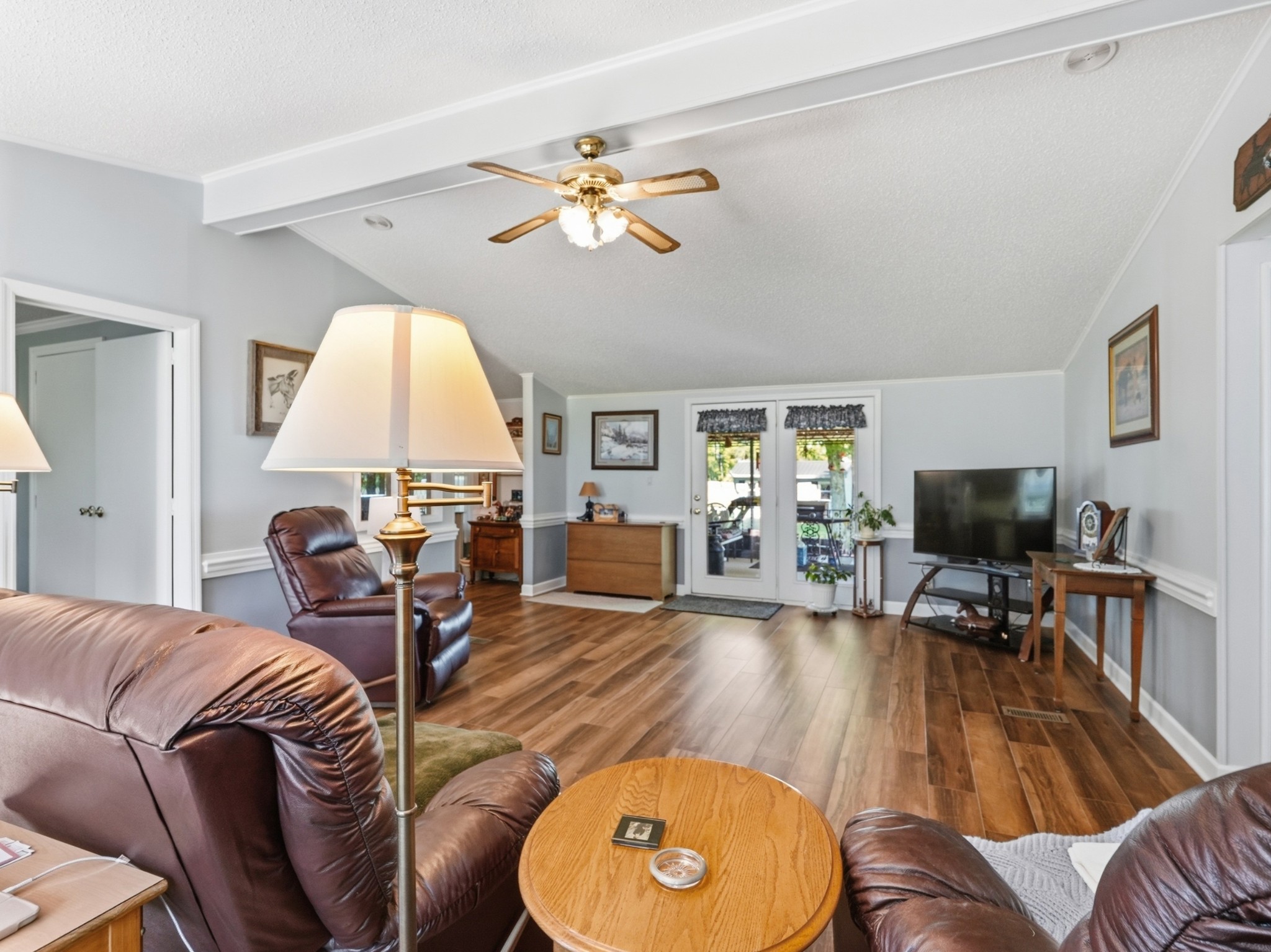 597 Hiwassee Road Lebanon, TN 37087 - Photo 12 of 37 a living room with furniture a fireplace and a flat screen tv