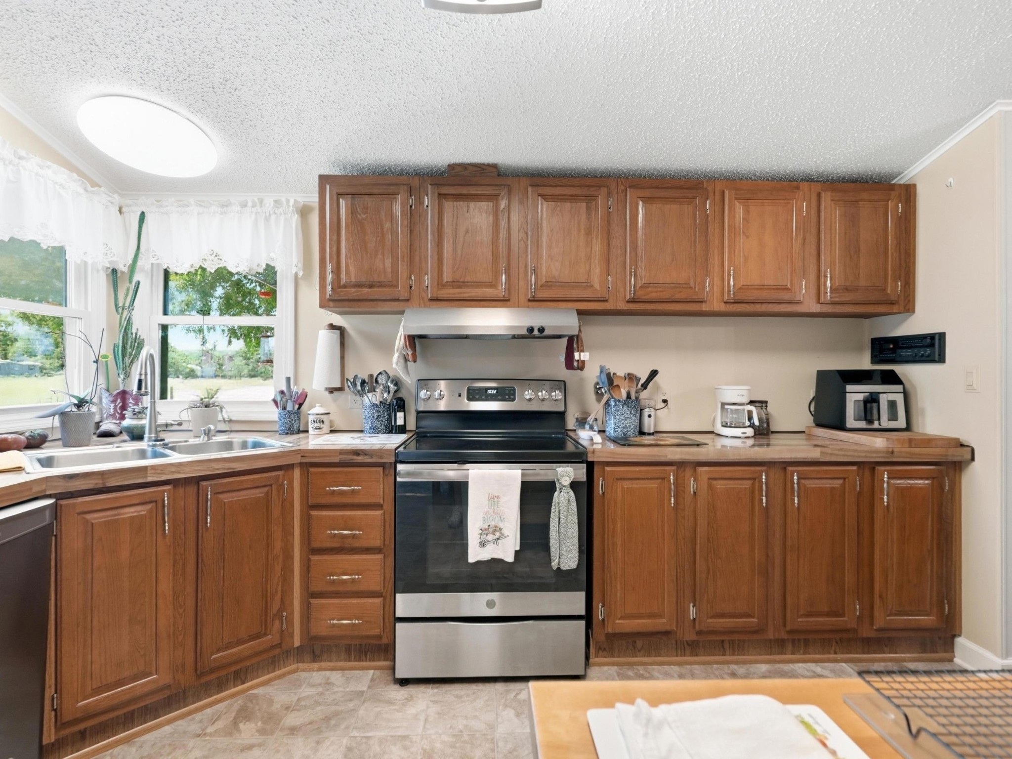 597 Hiwassee Road Lebanon, TN 37087 - Photo 16 of 37 a kitchen with stainless steel appliances granite countertop a stove a sink dishwasher and a microwave oven with cabinets