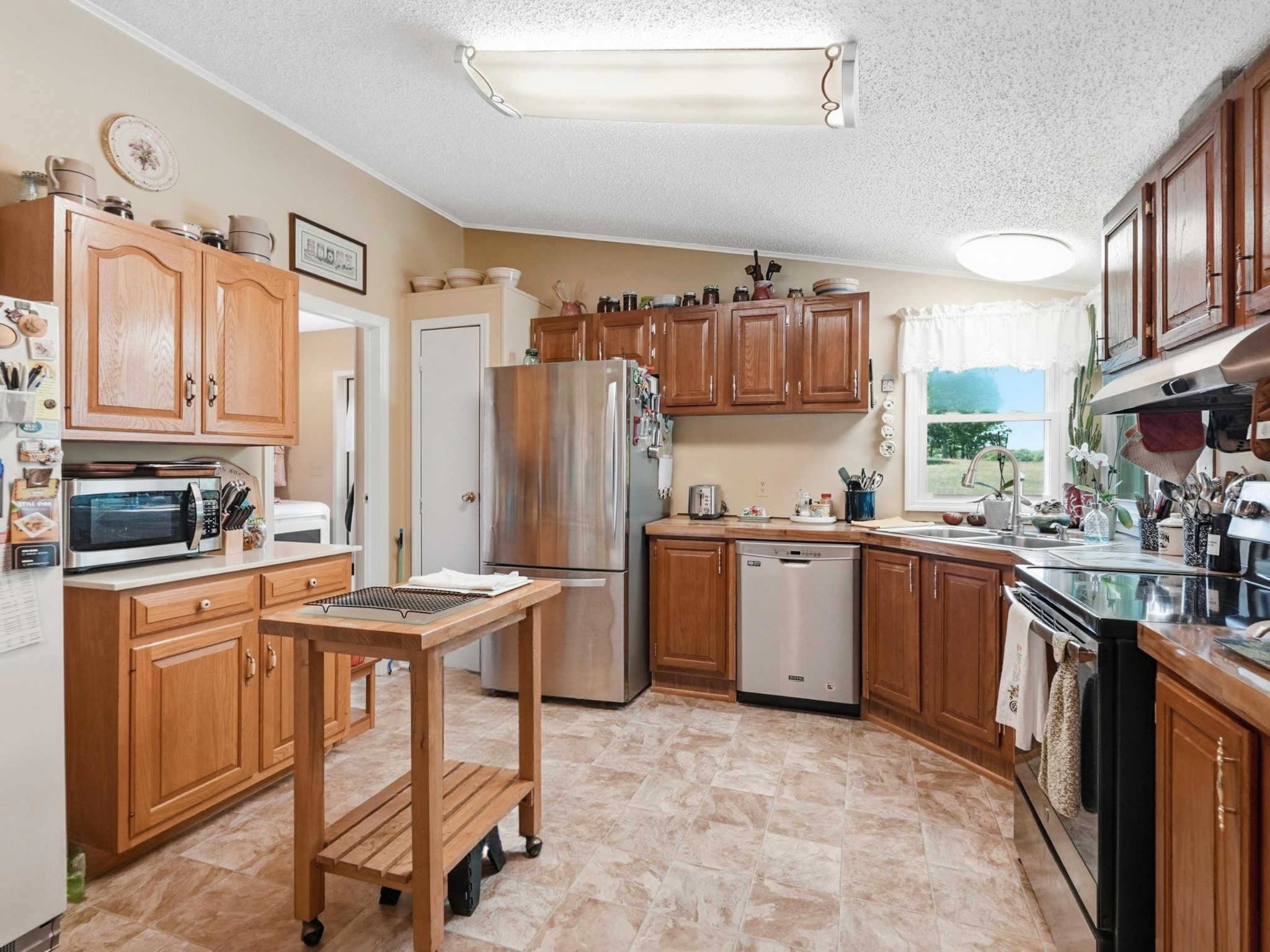 597 Hiwassee Road Lebanon, TN 37087 - Photo 17 of 37 a kitchen with a sink refrigerator and cabinets