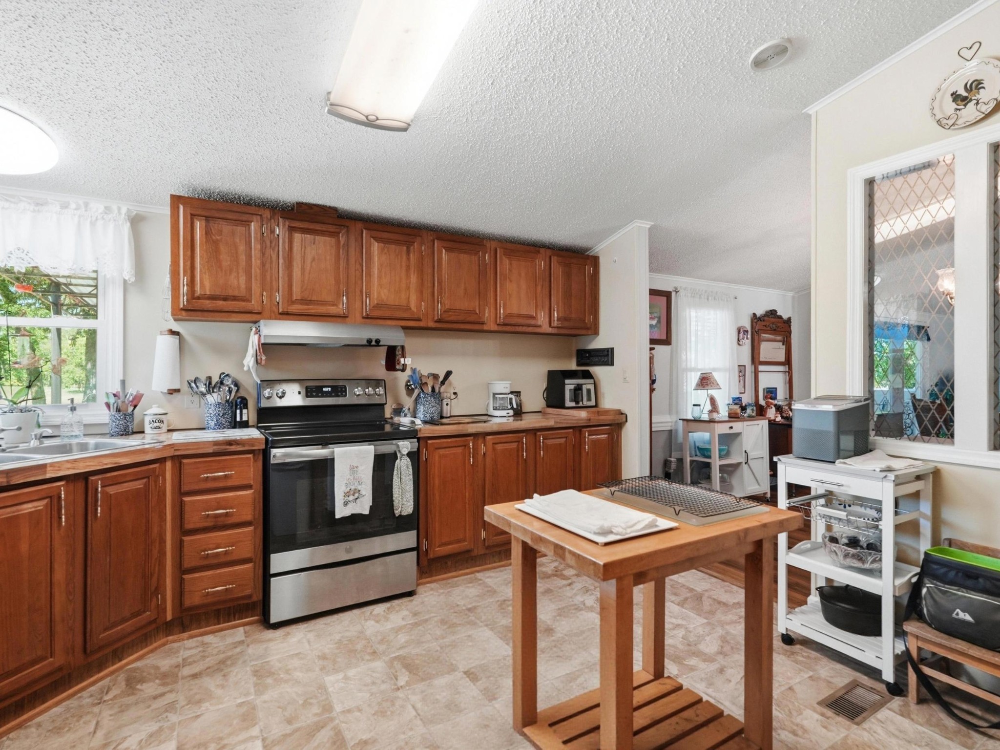 597 Hiwassee Road Lebanon, TN 37087 - Photo 18 of 37 a kitchen with stainless steel appliances granite countertop a stove a sink dishwasher and a refrigerator with wooden cabinets