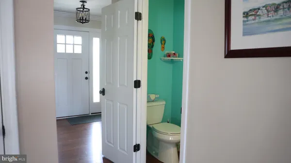 a bedroom with a bed a chandelier and dresser