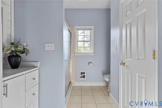 a view of a house with backyard and a tree