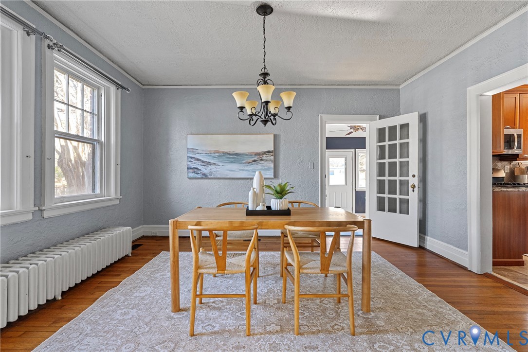 2517 Hilliard Road Henrico, VA 23228 - Photo 17 of 47 a dining room with furniture a chandelier and wooden floor