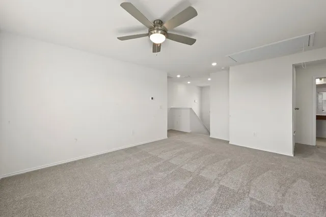 an empty room with fan and ceiling fan