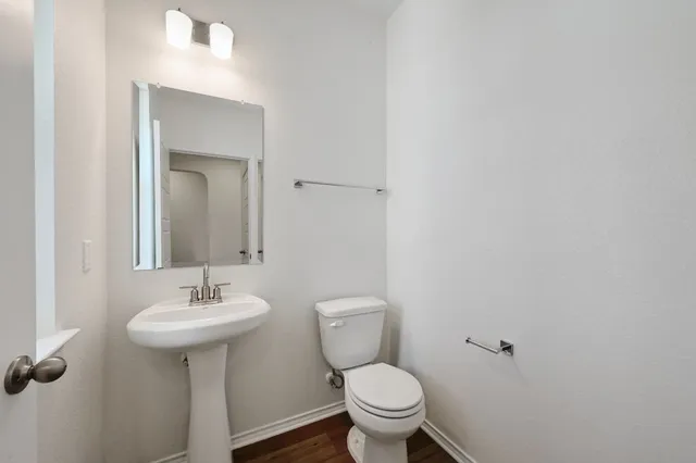 a bathroom with a sink toilet and a mirror