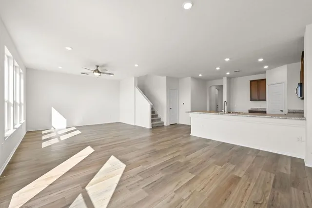 a view of kitchen with kitchen island sink and refrigerator