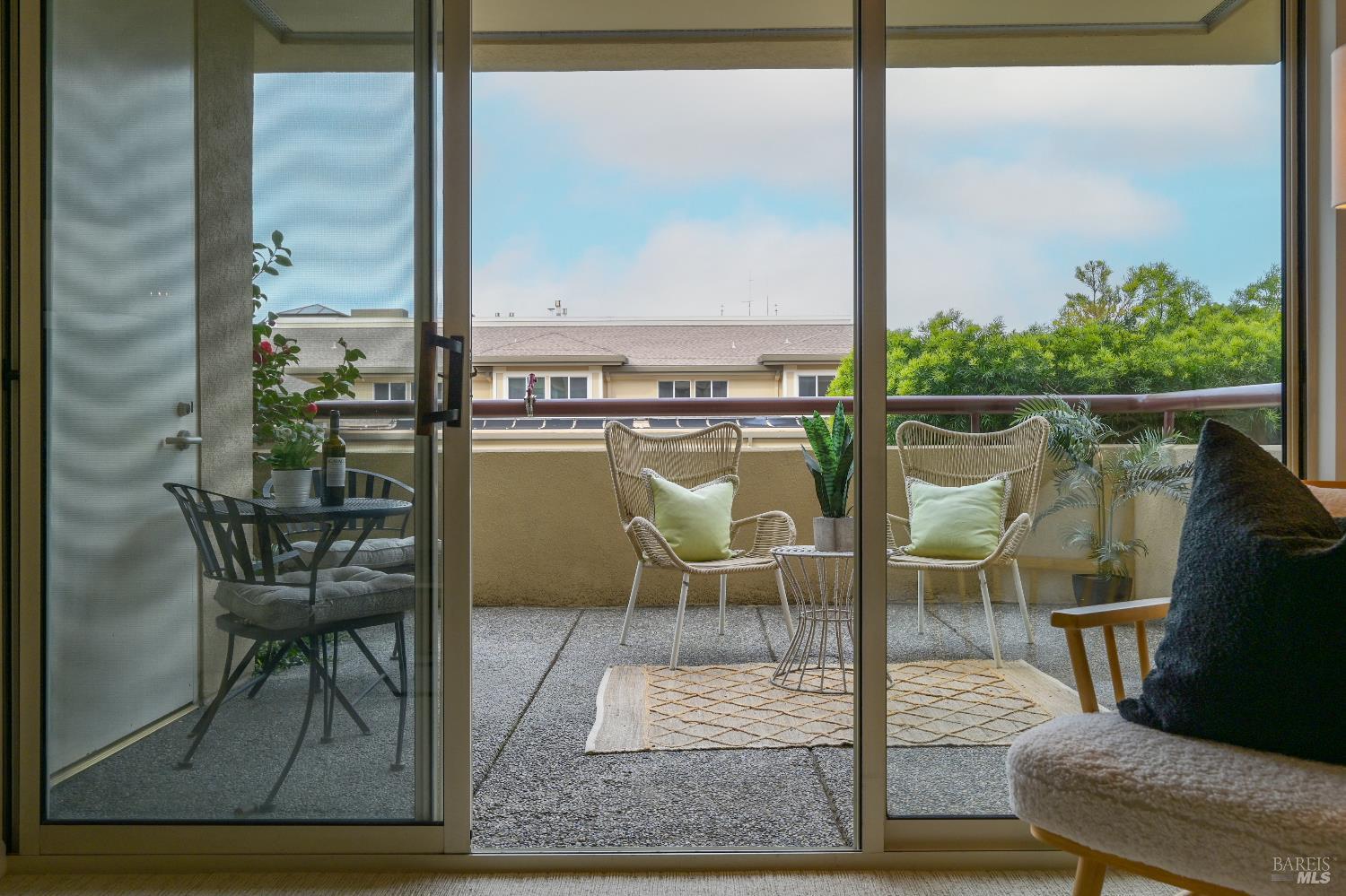 400 Deer Valley Road, Unit 2A San Rafael, CA 94903 - Photo 12 of 22 a balcony with table and chairs