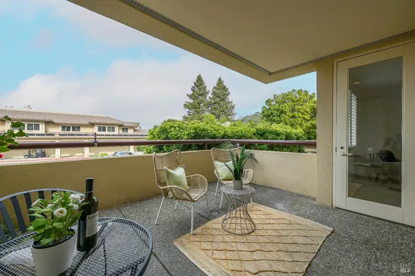 a balcony with table and chairs