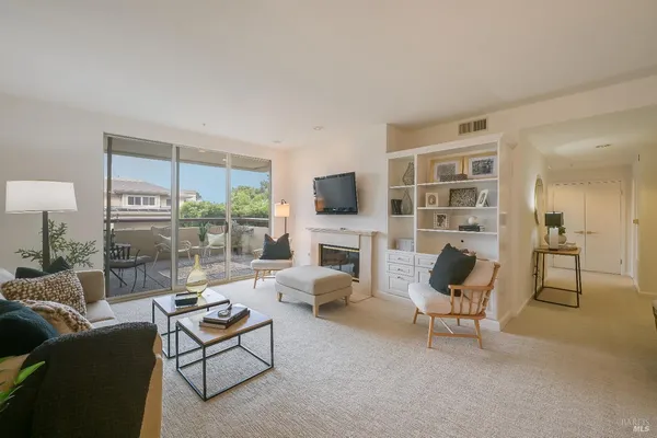 a living room with furniture and a fireplace