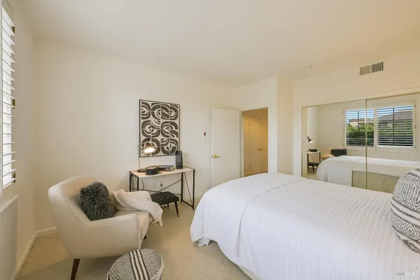a bedroom with a bed and glass window