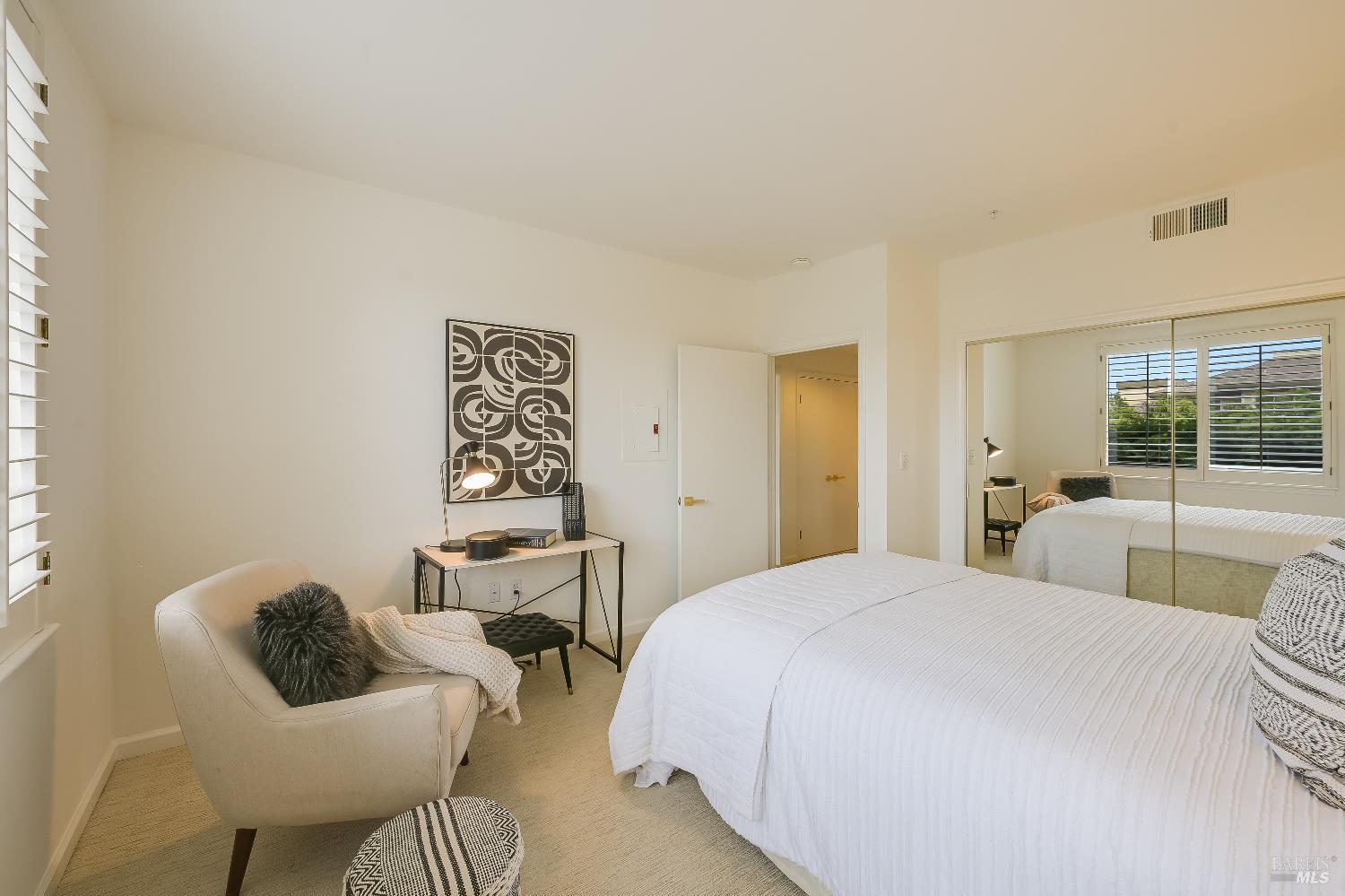 400 Deer Valley Road, Unit 2A San Rafael, CA 94903 - Photo 7 of 22 a bedroom with a bed and glass window