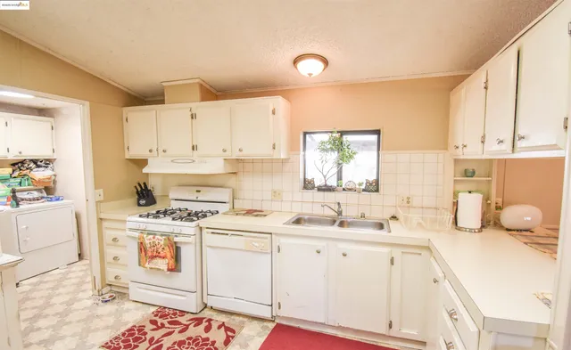 a kitchen with a sink stove and cabinets