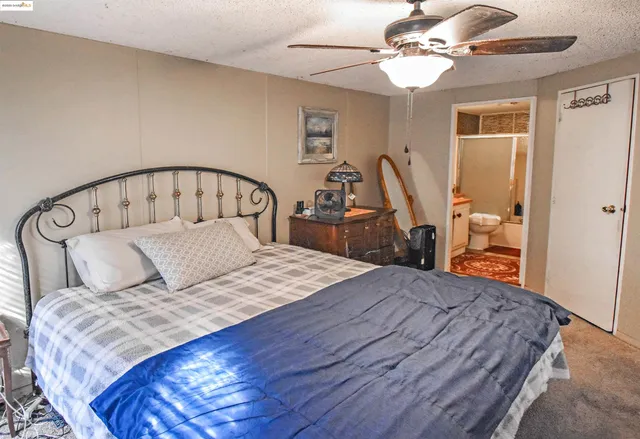 a bedroom with a bed and furniture with wooden floor