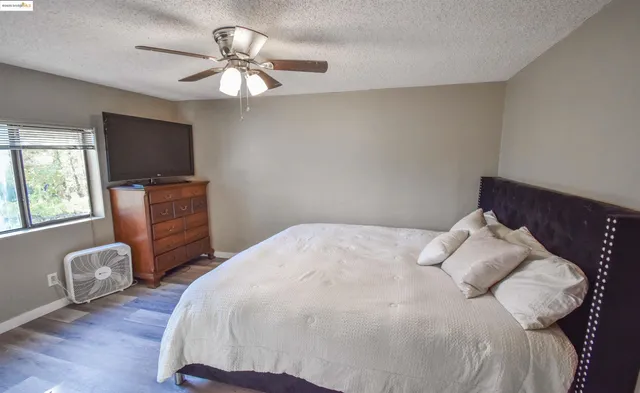 a bedroom with a large bed and a chandelier
