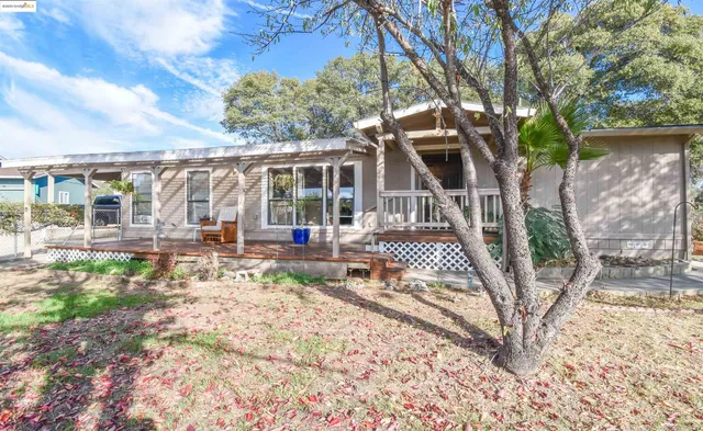 a view of a house with backyard and sitting area