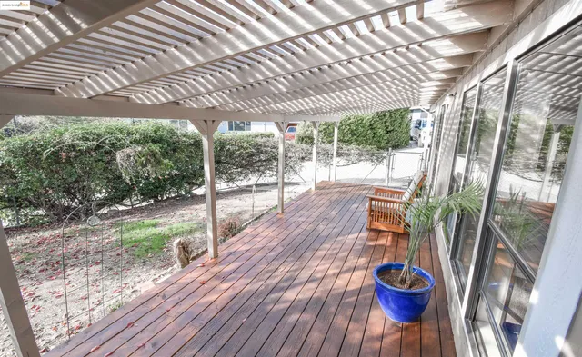 a view of a porch with furniture and wooden floor