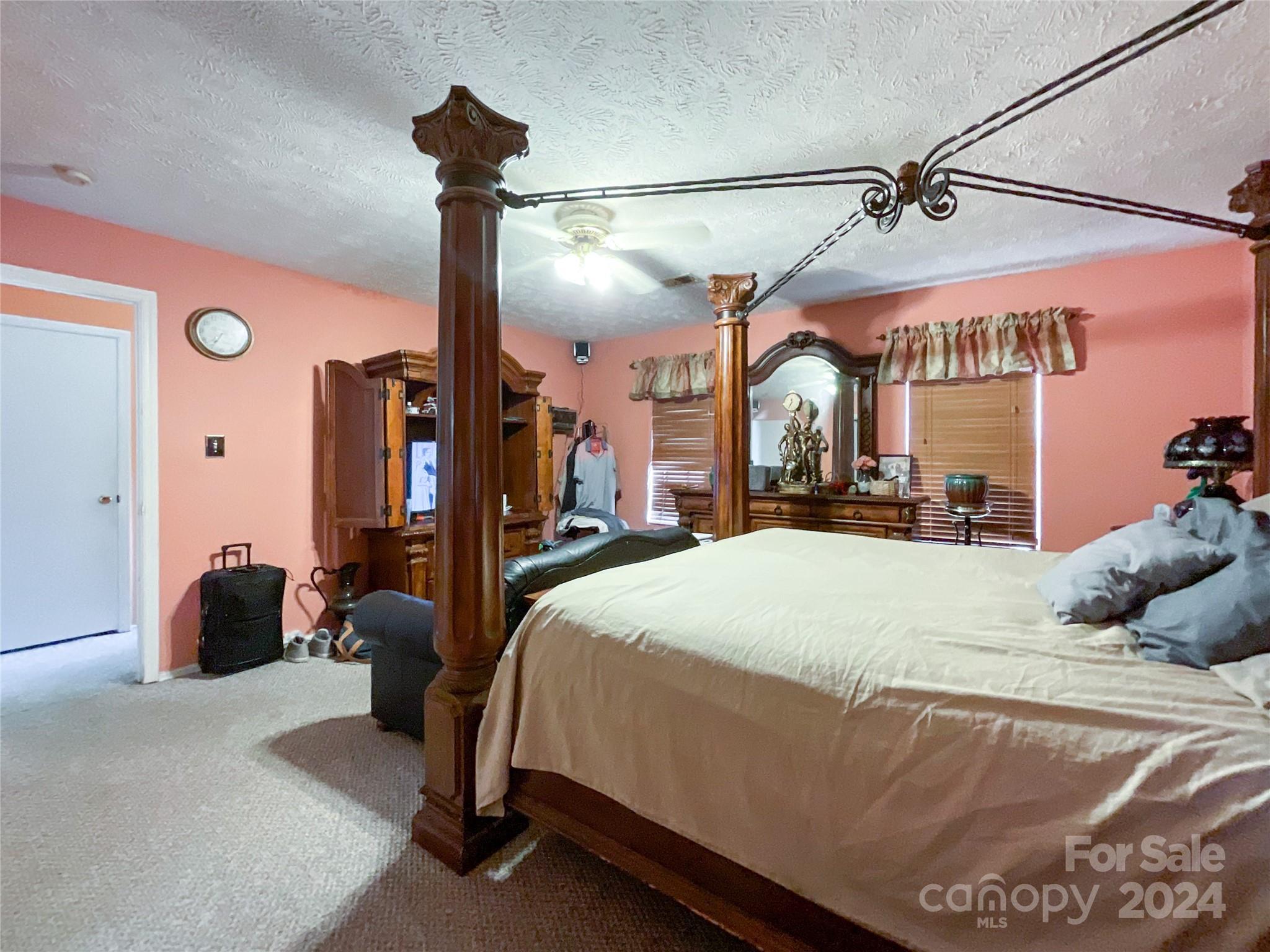 267 Homeplace Road Rockingham, NC 28379 - Photo 32 of 47 a bed room with a bed and a chandelier