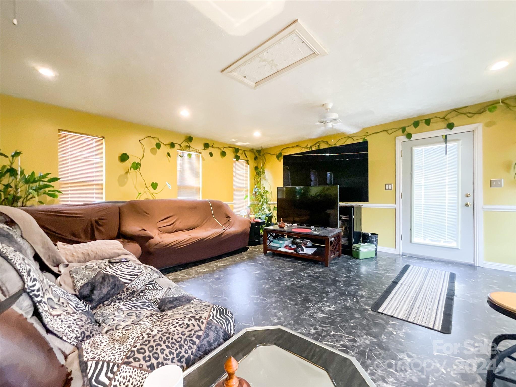 267 Homeplace Road Rockingham, NC 28379 - Photo 6 of 47 a living room with furniture and a flat screen tv