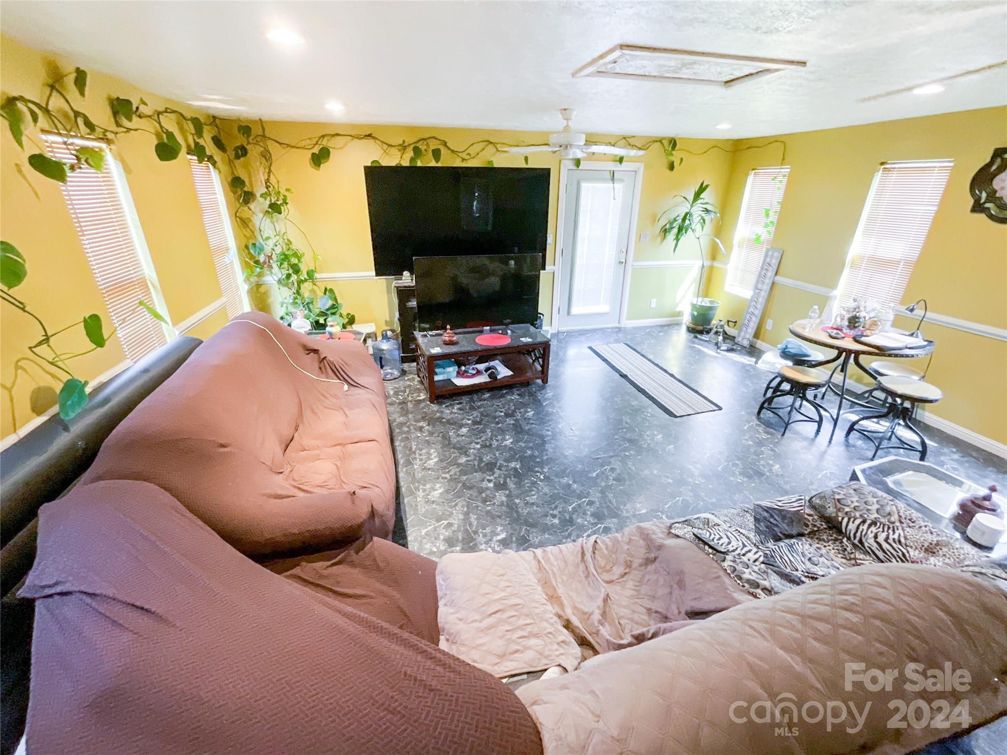 267 Homeplace Road Rockingham, NC 28379 - Photo 7 of 47 a living room with furniture and a flat screen tv