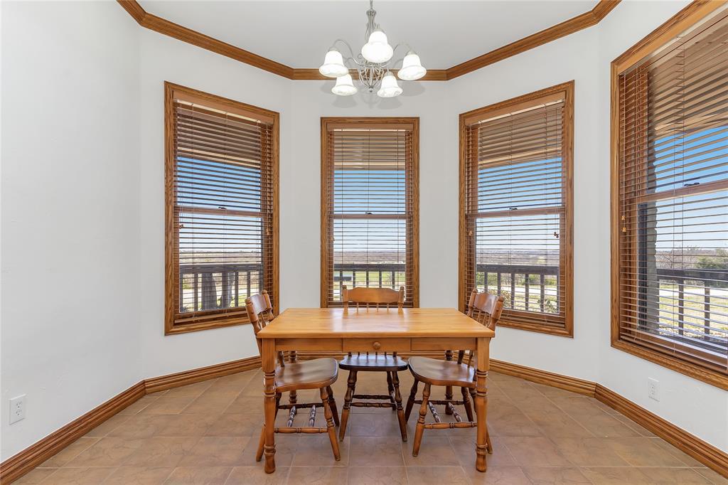 4520 South Nolan River Road Cleburne, TX 76033 - Photo 14 of 40 Dining space with an inviting chandelier, plenty of natural light, and ornamental molding