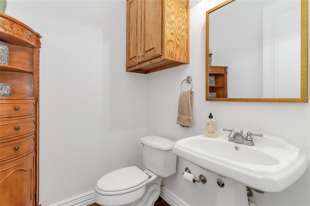 4520 South Nolan River Road Cleburne, TX 76033 - Photo 15 of 40 Half bath with toilet, baseboards, and a sink