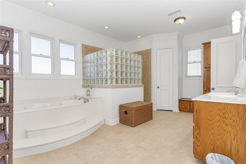 4520 South Nolan River Road Cleburne, TX 76033 - Photo 19 of 40 Full bath with visible vents, a garden tub, recessed lighting, crown molding, and vanity