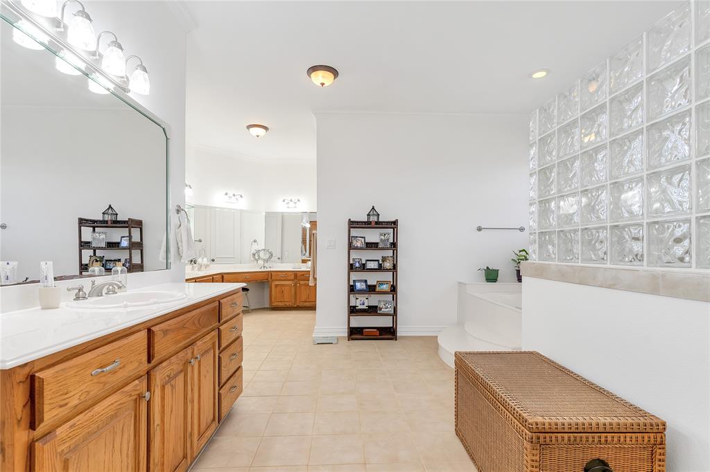 4520 South Nolan River Road Cleburne, TX 76033 - Photo 21 of 40 Full bath with vanity, baseboards, ornamental molding, tile patterned flooring, and a bathtub