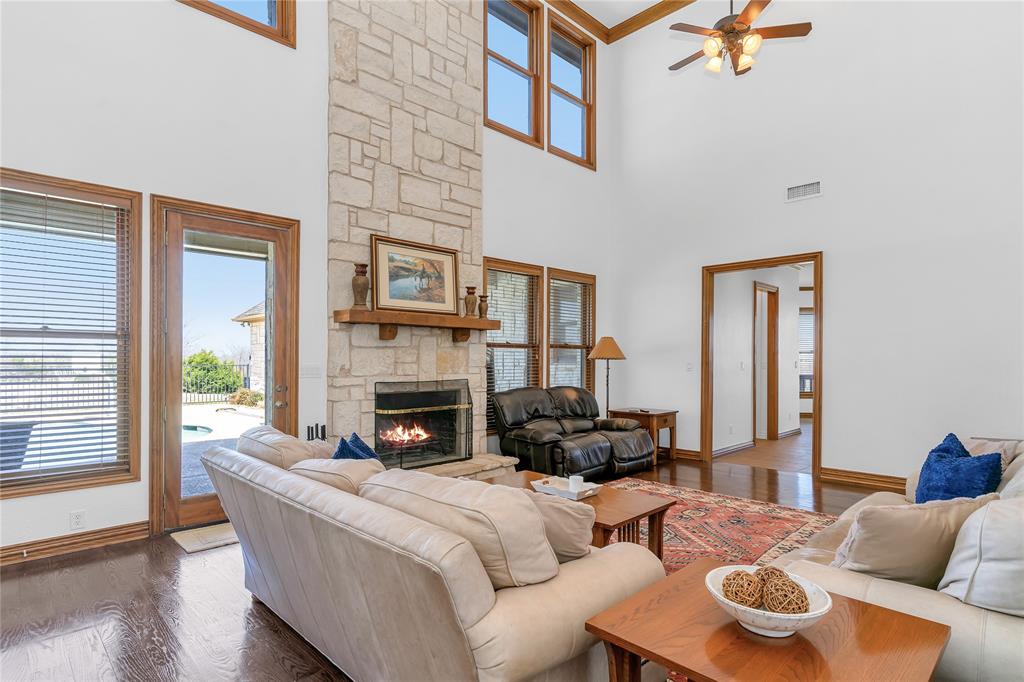 4520 South Nolan River Road Cleburne, TX 76033 - Photo 23 of 40 Living room featuring visible vents, a fireplace, a ceiling fan, and wood finished floors
