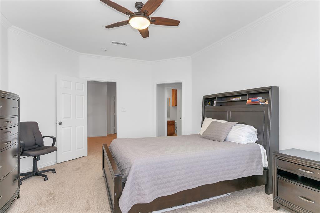 4520 South Nolan River Road Cleburne, TX 76033 - Photo 29 of 40 Bedroom with visible vents, light carpet, ornamental molding, a ceiling fan, and baseboards