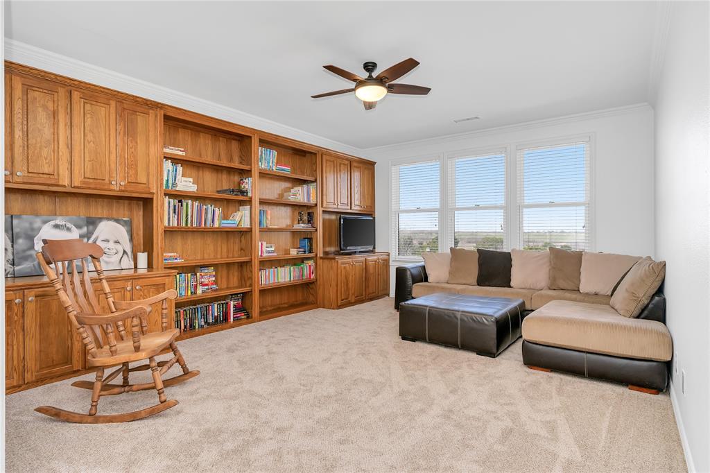 4520 South Nolan River Road Cleburne, TX 76033 - Photo 36 of 40 Living area with crown molding, a ceiling fan, and carpet floors