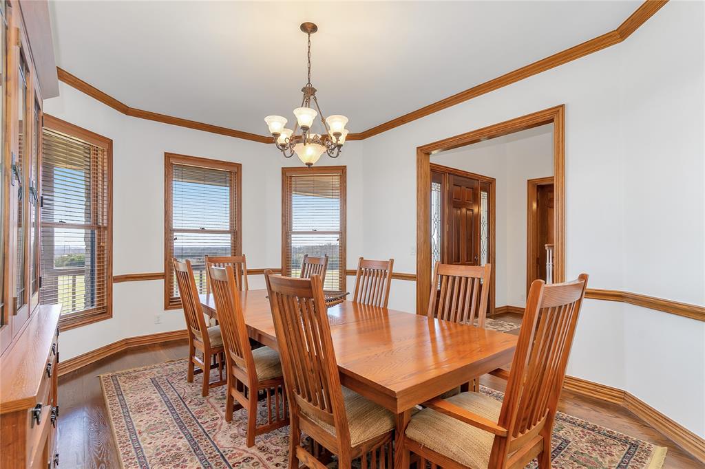 4520 South Nolan River Road Cleburne, TX 76033 - Photo 10 of 40 Dining space with ornamental molding, light wood-style flooring, plenty of natural light, and a chandelier