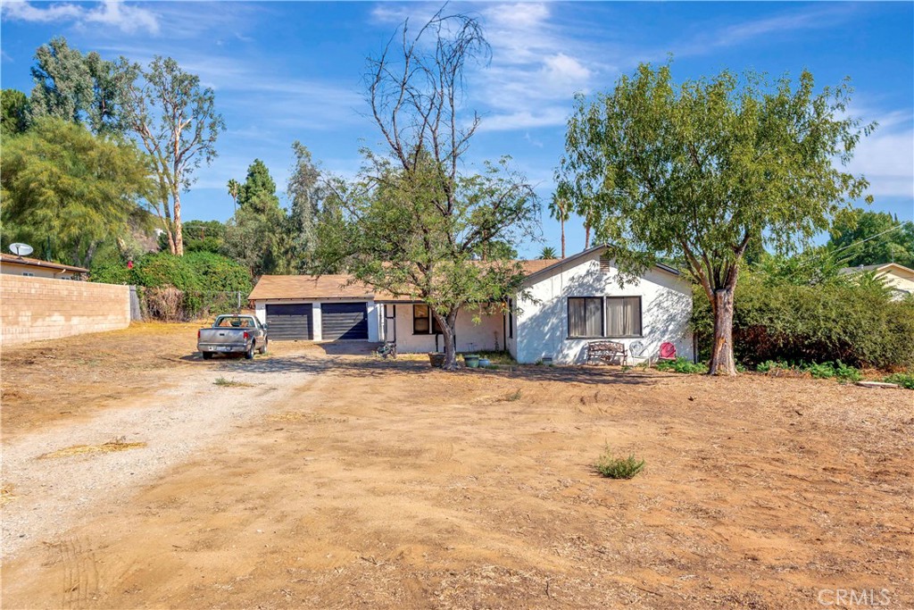 a view of a house with a yard and sitting area