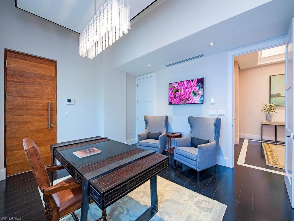 490 5th Street South, Unit 101 Naples, FL 34102 - Photo 11 of 34 a living room with furniture and a table