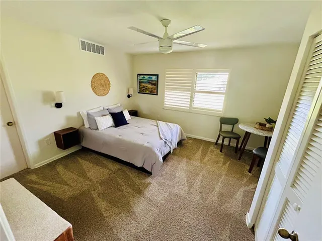 a bedroom with a bed and a large window