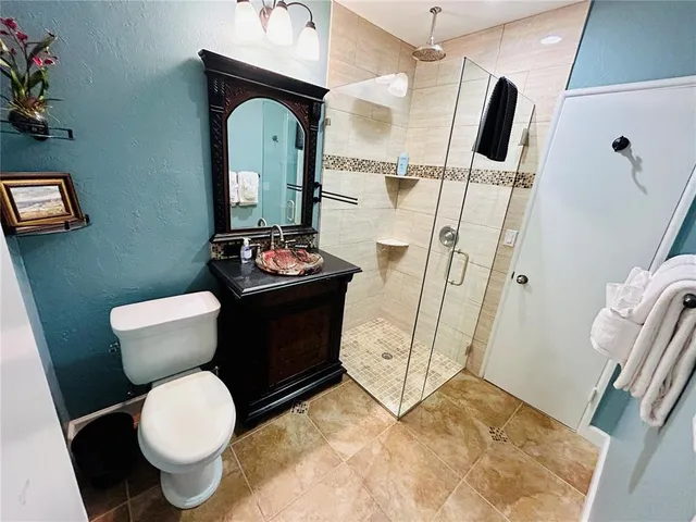 a bathroom with a sink toilet and shower