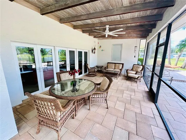 a living room with furniture and a floor to ceiling window