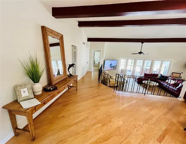 a dining room with furniture and a floor to ceiling window