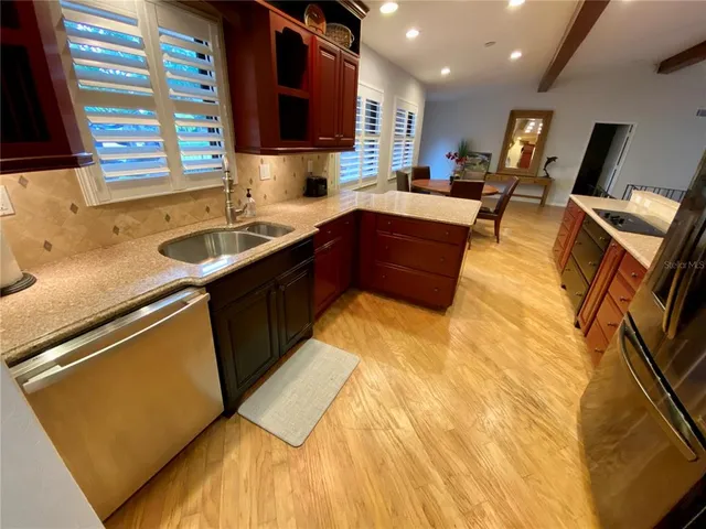 a kitchen with a sink appliances and cabinets