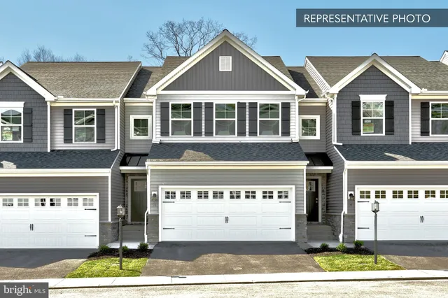 a front view of a building with a garden